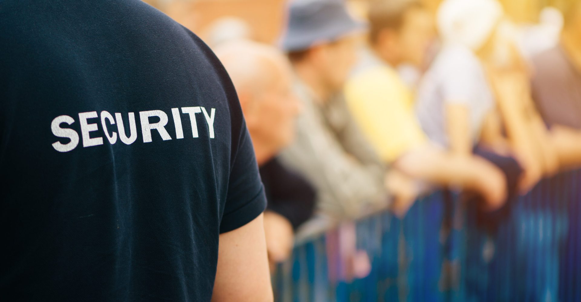 Member of security guard team on public event Member of security guard team working on public event, unrecognizable male person from behind